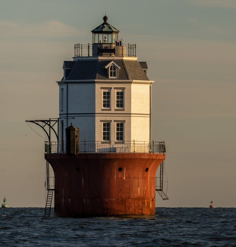 Chesapeake Bay lighthouse on calm water — the bay we protect with every clean